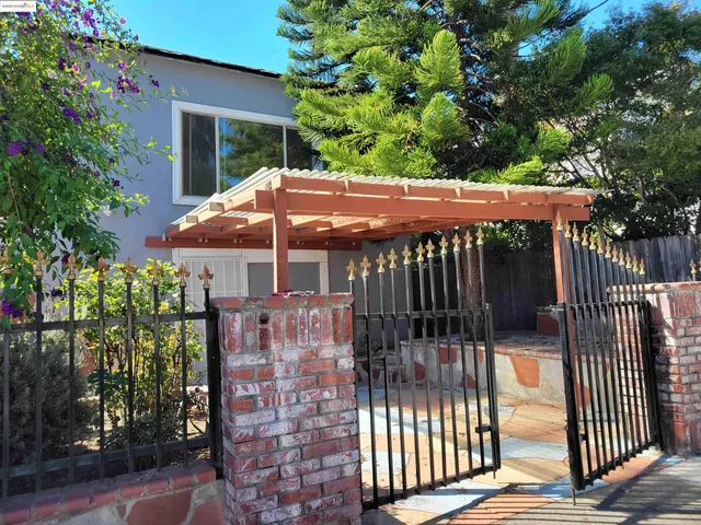 a view of a patio with a table and chairs