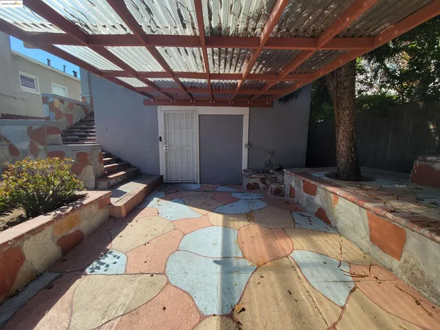 a view of a porch with furniture and a yard