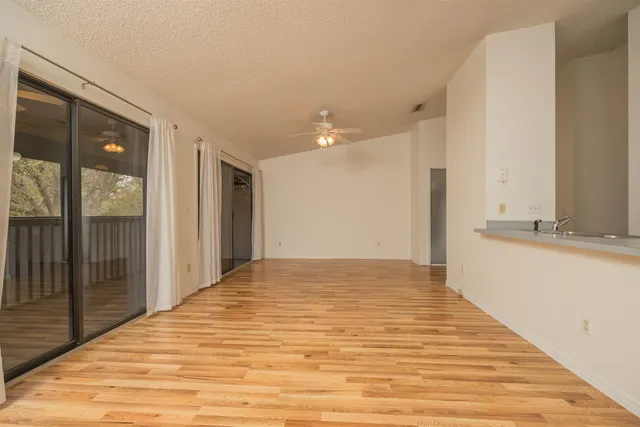 a large kitchen with kitchen island a sink dishwasher stove and oven with wooden floor
