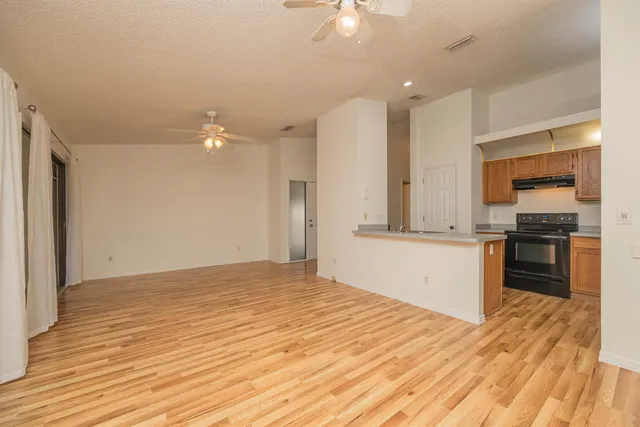a kitchen with stainless steel appliances granite countertop a sink stove and cabinets