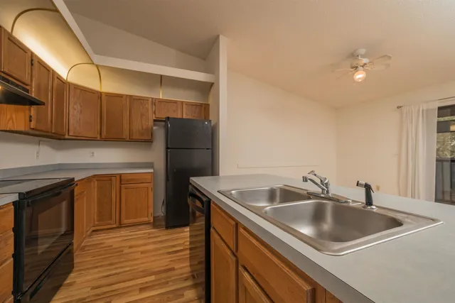 an empty room with a window and a ceiling fan