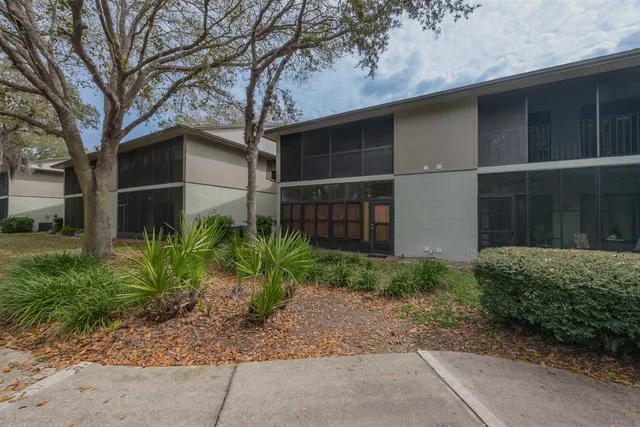 a backyard of a house with plants and trees