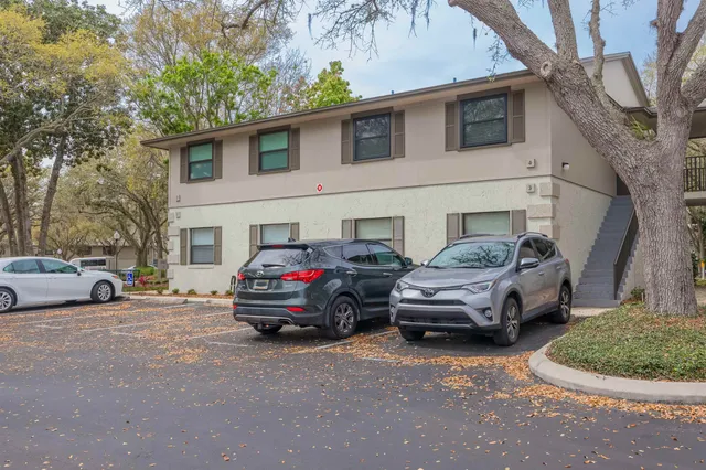 a car parked in front of white house