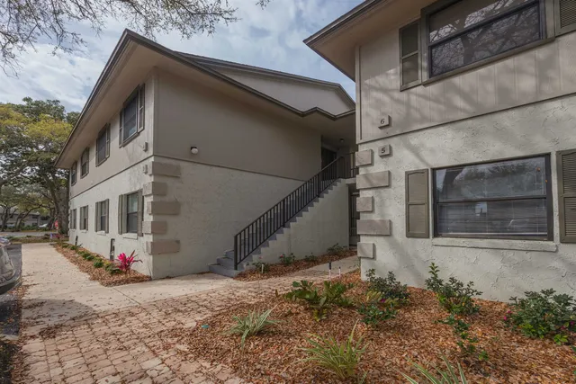 a view of wooden house with a yard