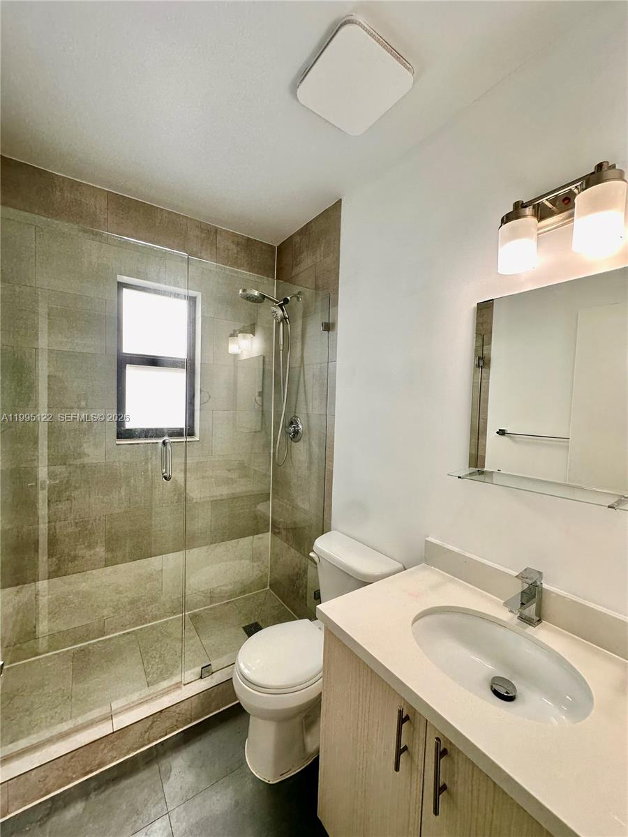 4203 Southwest 15th Street, Unit 2 Miami, FL 33145 - Photo 12 of 17 a bathroom with a sink toilet and shower
