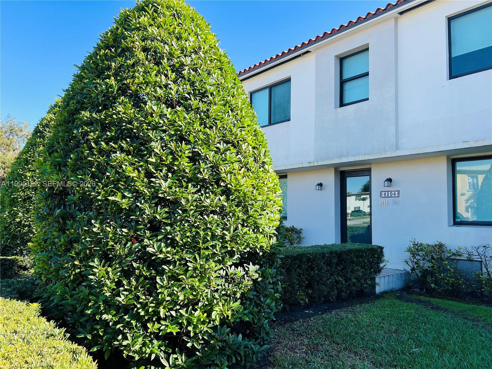 4203 Southwest 15th Street, Unit 2 Miami, FL 33145 - Photo 2 of 17 a front view of a house with a yard