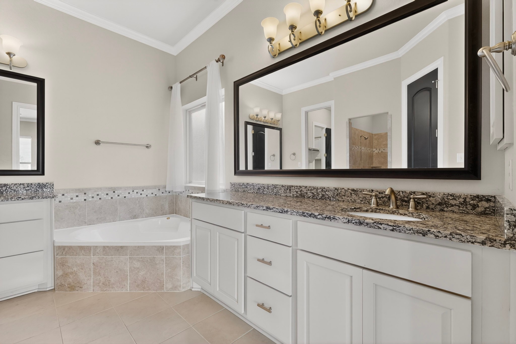 2617 Milan Meadows Drive Leander, TX 78641 - Photo 14 of 40 Indulge in a primary bathroom offering a soaking tub, dual vanities, and ample counter space.