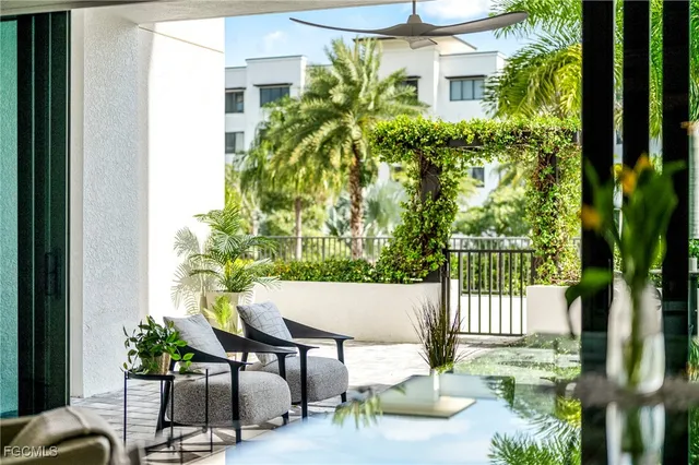 a view of a patio with table and chairs and potted plants