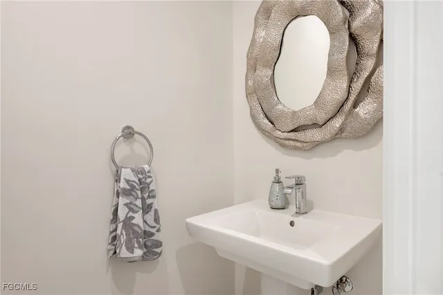 a bathroom with a sink and mirror