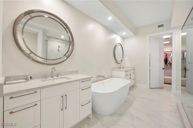 a spacious bathroom with a granite countertop toilet a sink and a mirror