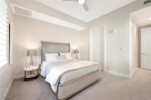 a bedroom with a bed and a lamp