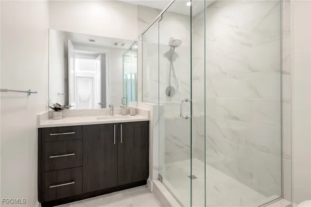 a bathroom with a shower sink and mirror