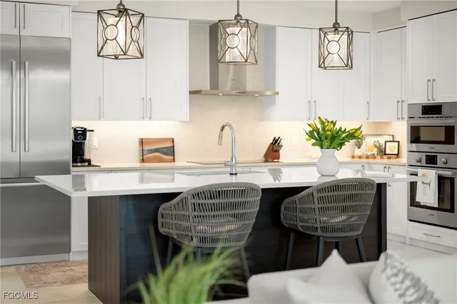 a kitchen with granite countertop a sink stainless steel appliances and cabinets