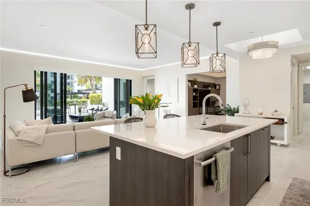 a view of a kitchen with a sink and a large window