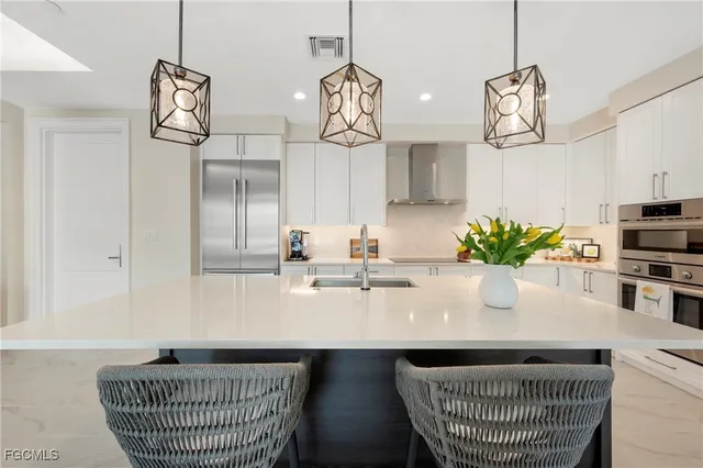 a kitchen with a sink and a chandelier