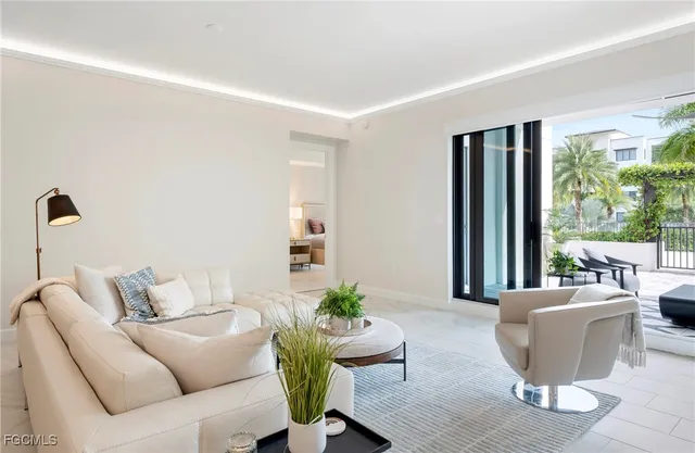 a living room with furniture and a potted plant