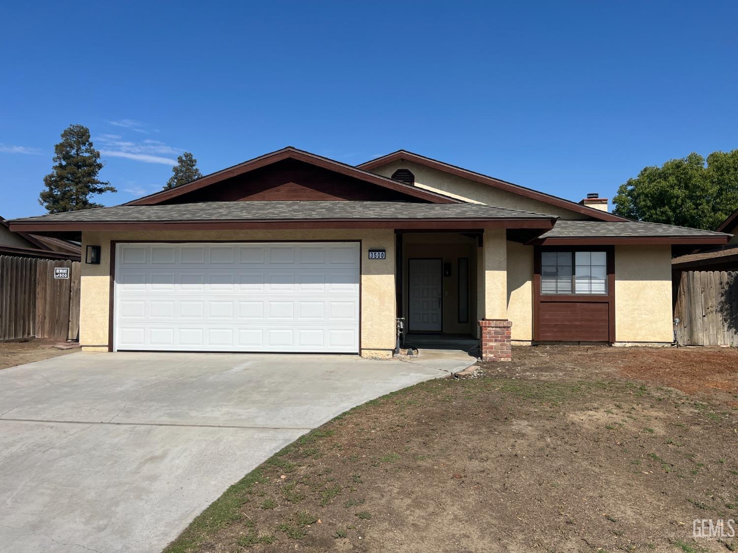 a front view of a house with a garage and yard