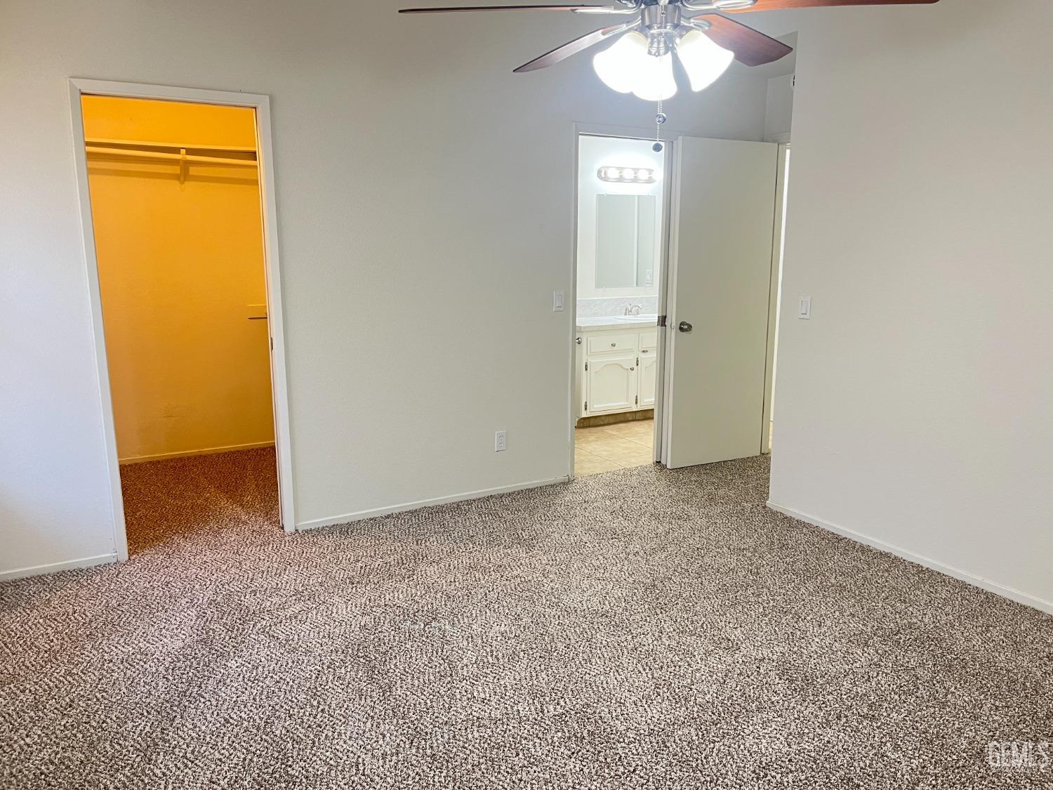 Undisclosed Address Bakersfield, CA 93311 - Photo 11 of 12 an empty room with a chandelier fan and closet