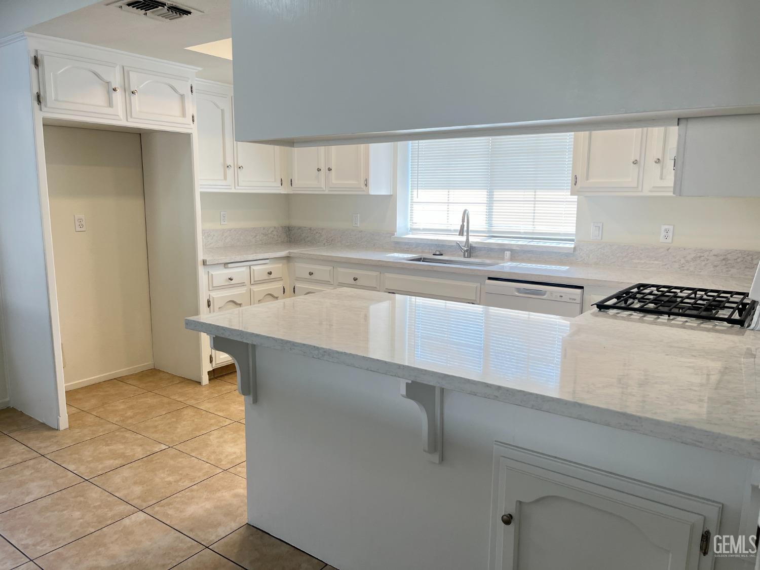 Undisclosed Address Bakersfield, CA 93311 - Photo 4 of 12 a kitchen with stainless steel appliances a sink stove and cabinets