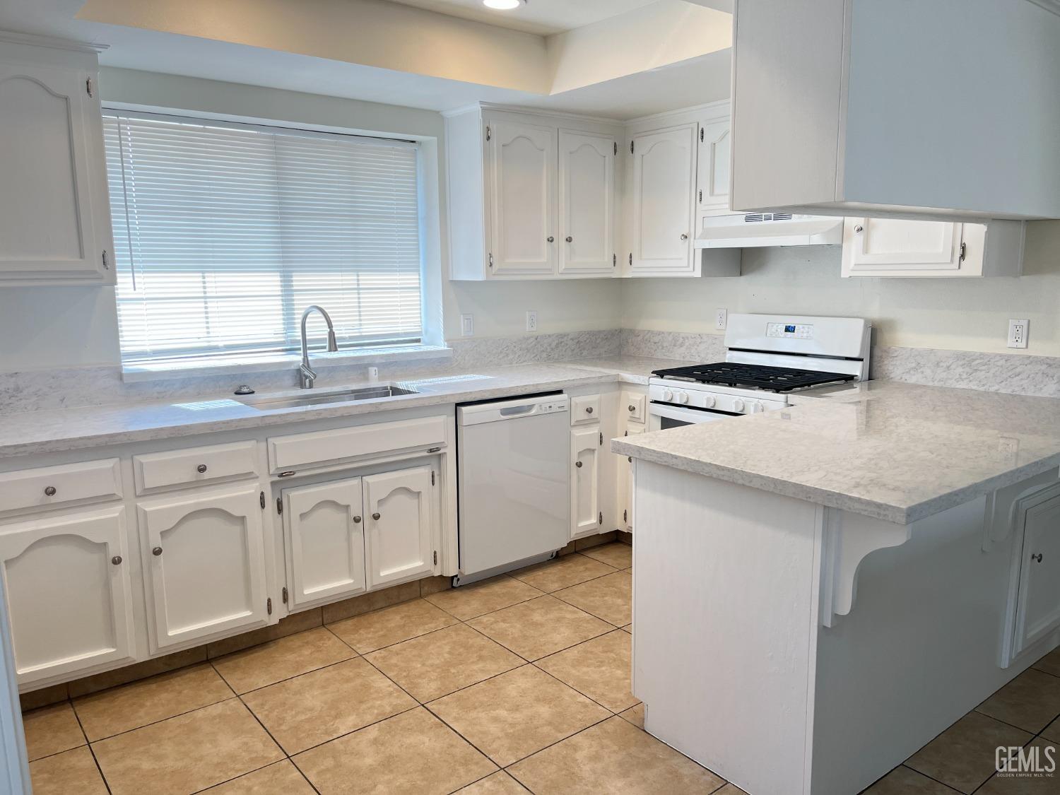 Undisclosed Address Bakersfield, CA 93311 - Photo 5 of 12 a kitchen with cabinets appliances a sink and a window