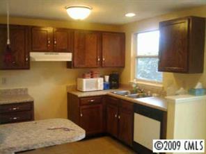 6633 Piney Path Road Charlotte, NC 28212 - Photo 5 of 6 a kitchen with a sink a stove and cabinets