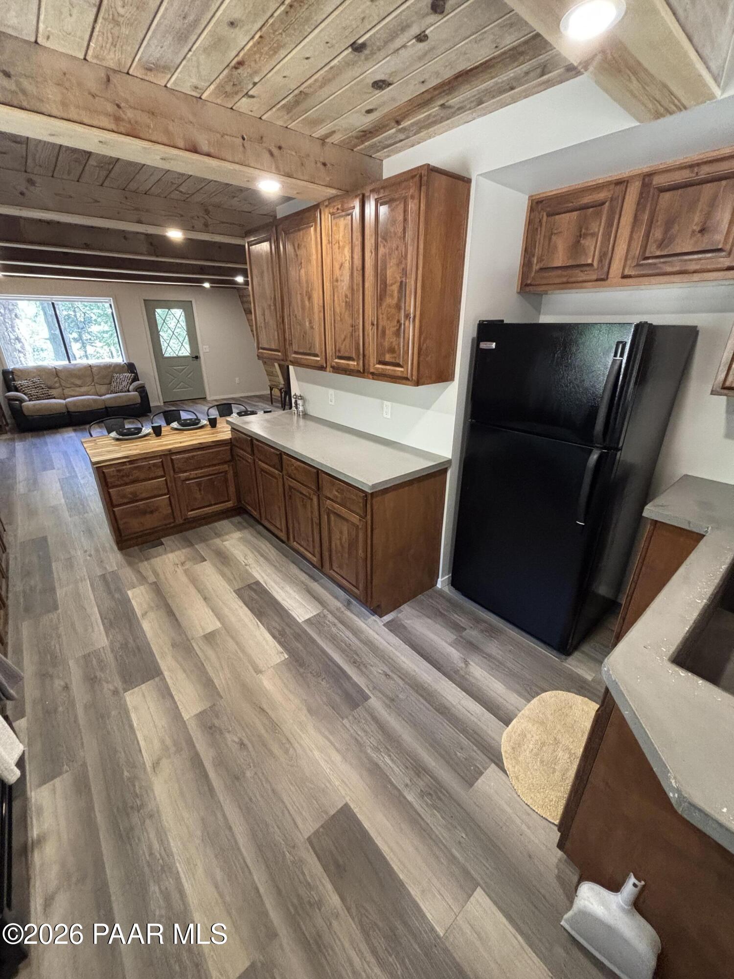 8550 South Breezy Pine Road Mayer, AZ 86333 - Photo 18 of 40 a kitchen with stainless steel appliances kitchen island granite countertop a refrigerator and a stove