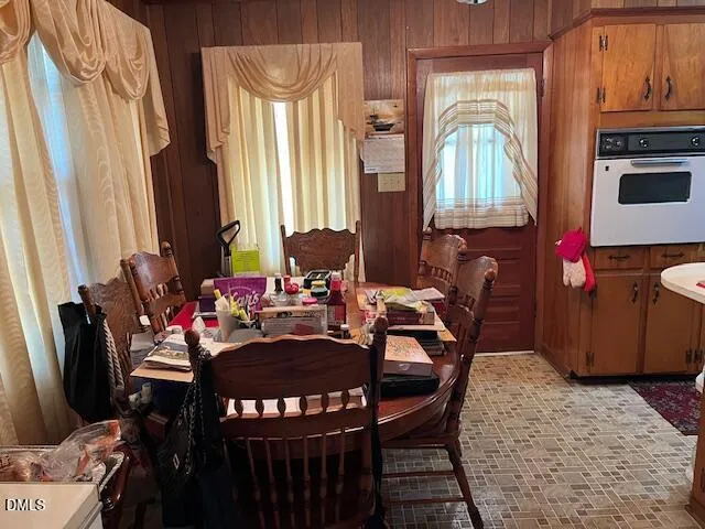 a view of a dining room with furniture and a window