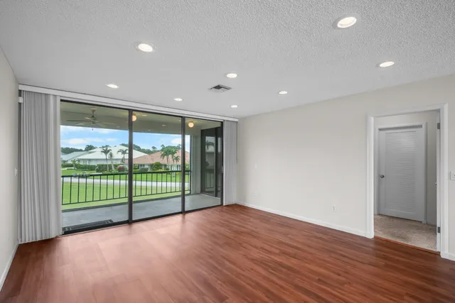a view of a room with wooden floor and large window