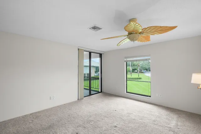 a bathroom with a granite countertop sink toilet and mirror
