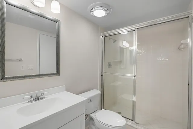 a bathroom with a sink mirror and toilet