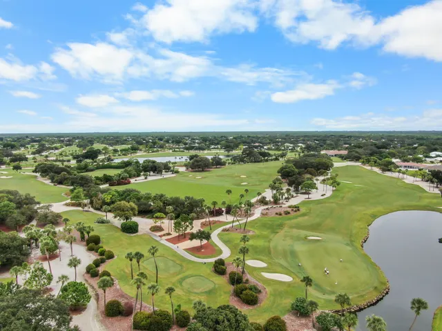 a view of a swimming pool with a patio and a yard