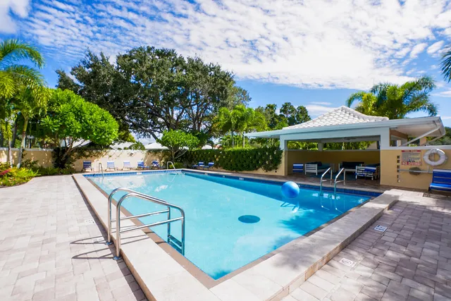 a view of a street with potted plants