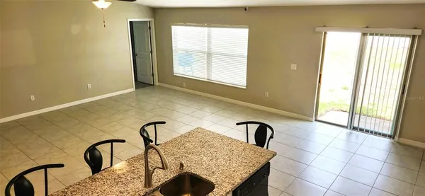 a bathroom with a granite countertop sink and a bathtub