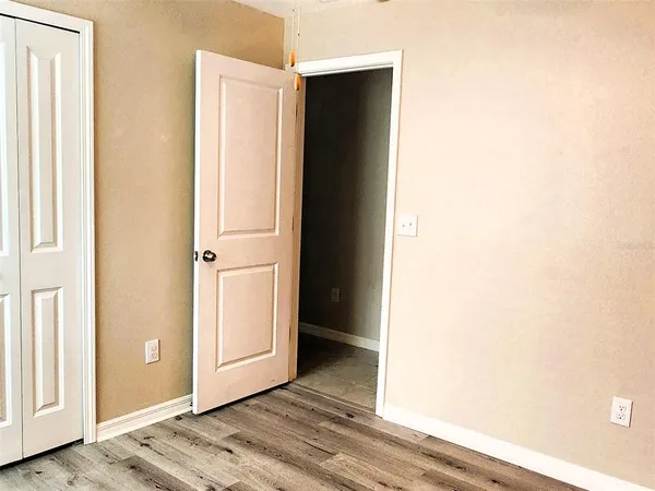a view of a room with wooden floor