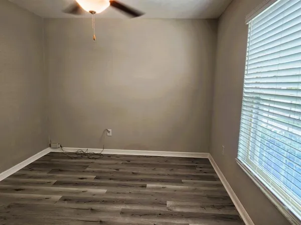 a view of room with window and hardwood floor