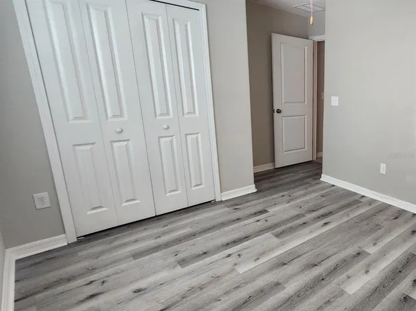 a view of wooden floor and closet area