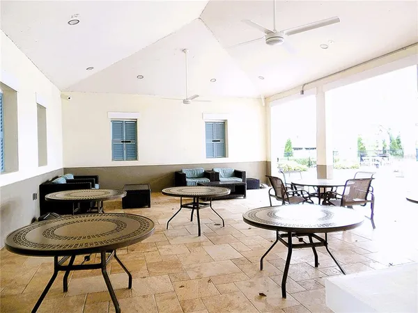 a living room with furniture a rug and a large window
