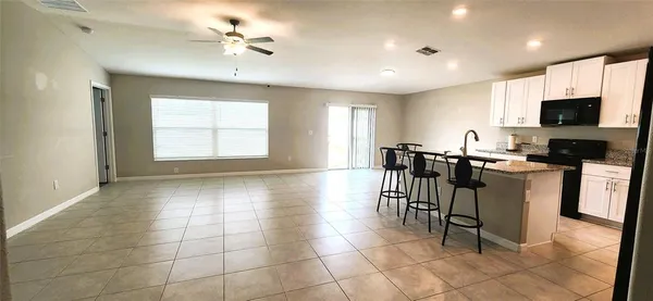 a view of a dining room with furniture and a window