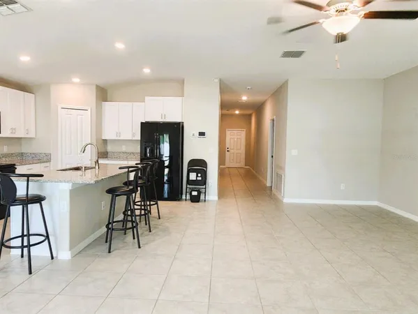 a view of kitchen with cabinets and window