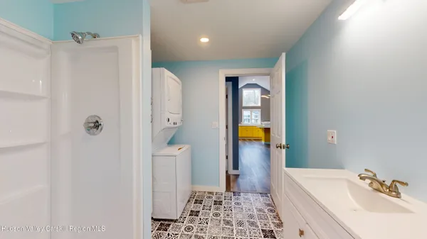 a bathroom with a sink a toilet and shower