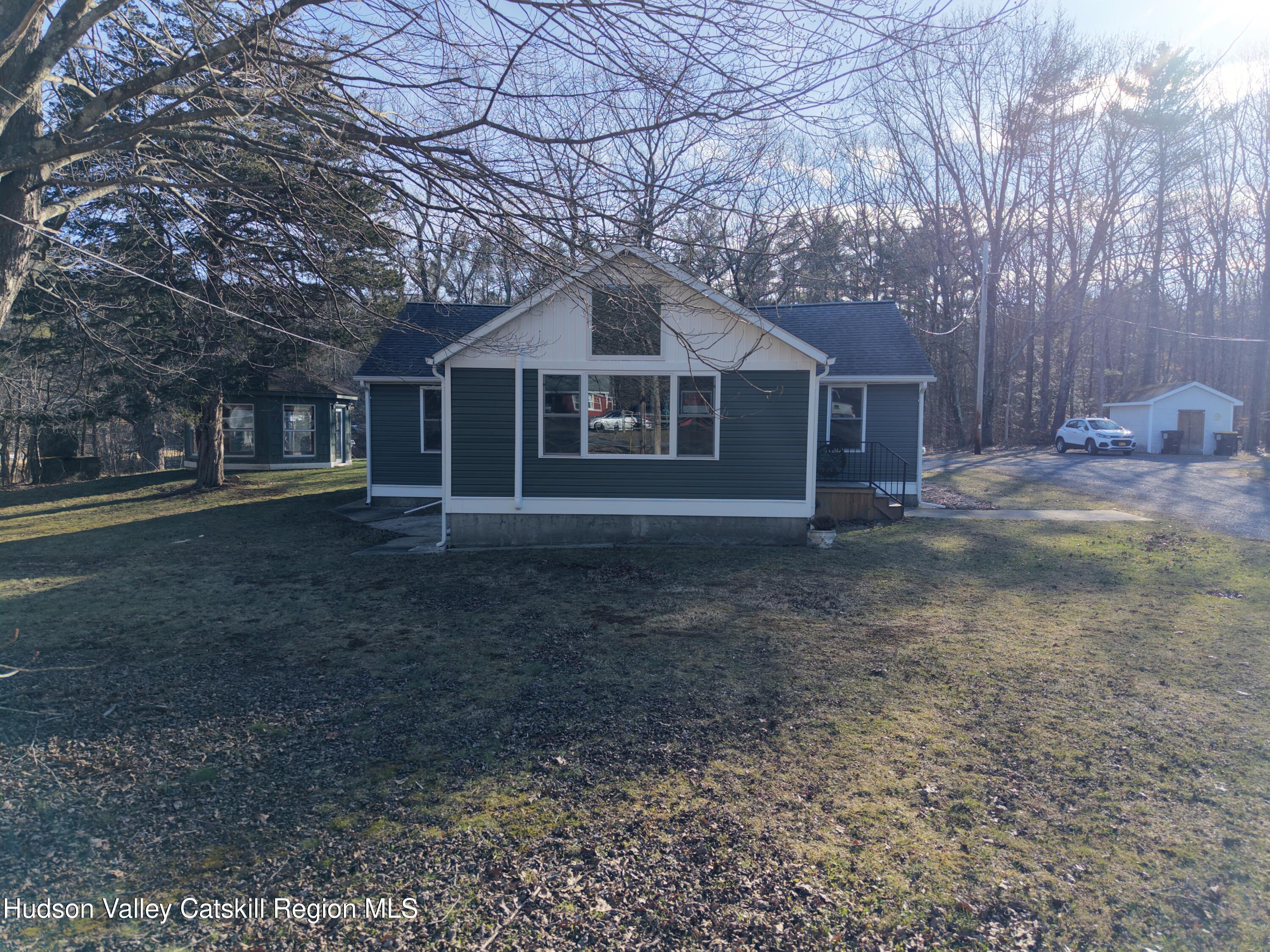 79 Highway 145 Cairo, NY 12413 - Photo 18 of 23 a front view of a house with a yard and trees