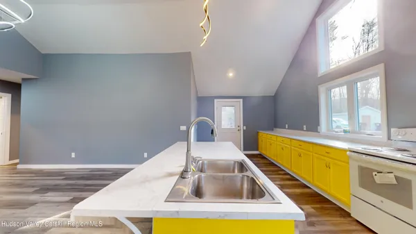 a kitchen with a sink and a stove top oven
