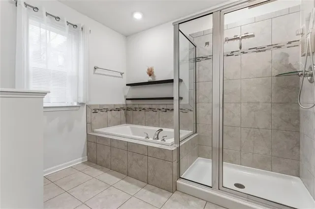 a bathroom with a tub a sink and a mirror