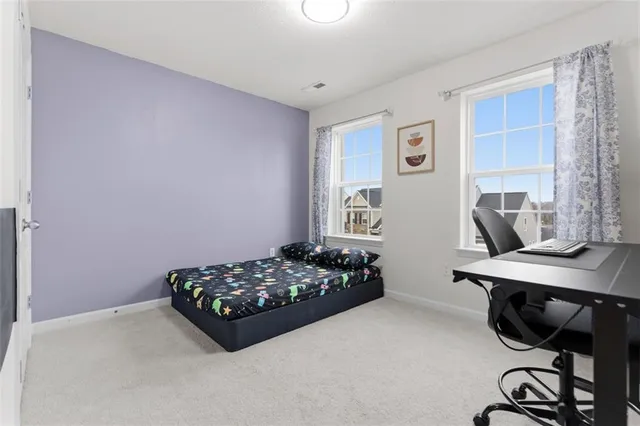 a bedroom with a bed and a desk