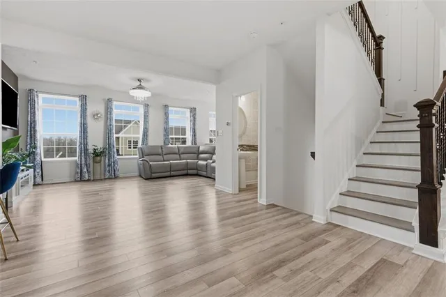 a view of a livingroom with furniture wooden floor and windows