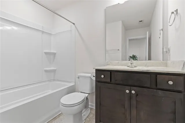 a bathroom with a sink toilet vanity and tub