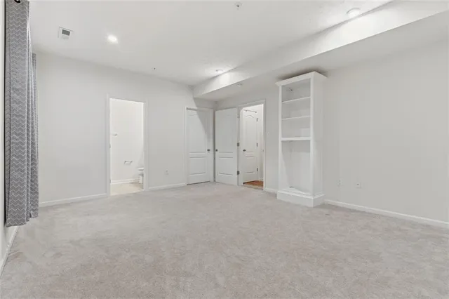 an empty room with closet area