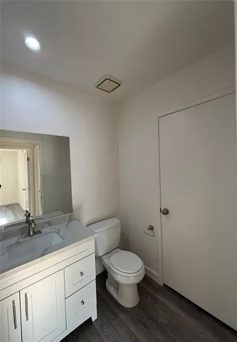 a bathroom with a toilet a sink and mirror
