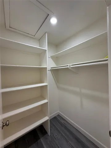 a view of walk in closet with empty racks