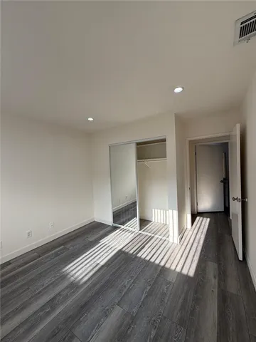 a view of an empty room and wooden floor